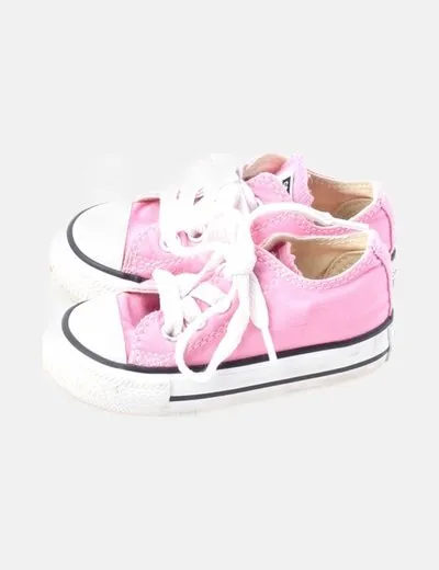 Pink canvas Converse sneakers with rubber toe cap.